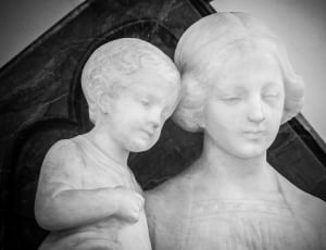 woman beside baby statue thumbnail
