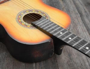 sunburst dreadnought acoustic guitar on brown wooden surface thumbnail