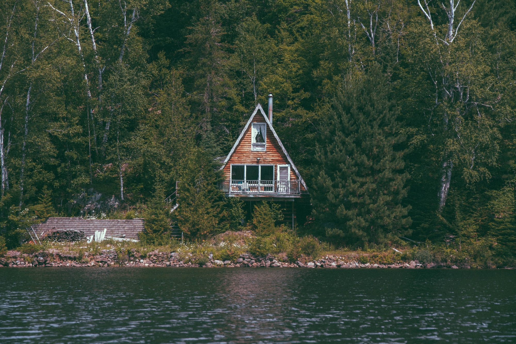 brown wooden house and body of water