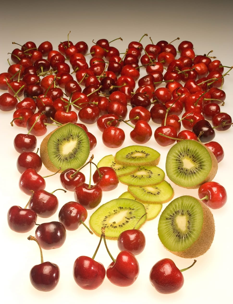 sliced kiwi fruits and red cherries preview