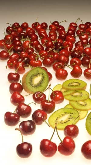 sliced kiwi fruits and red cherries thumbnail