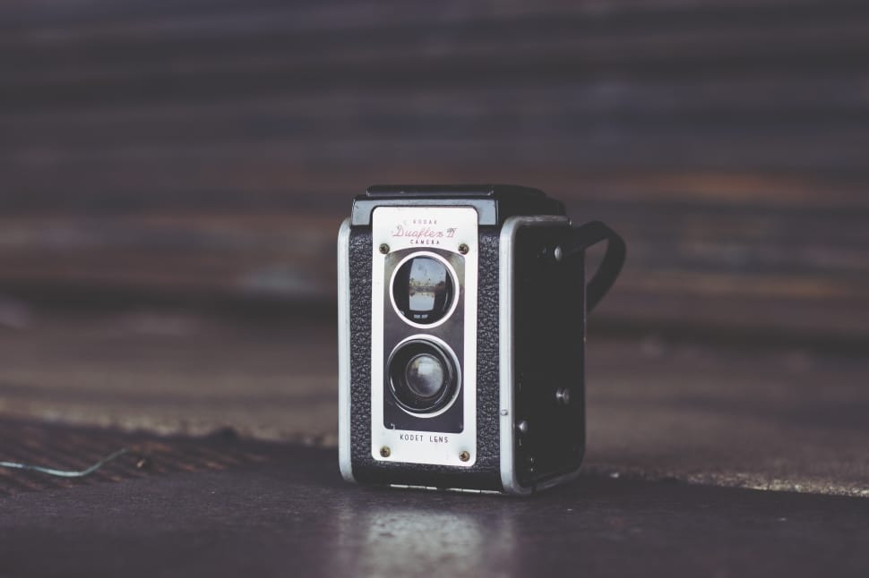 black and white camera on brown wooden top preview