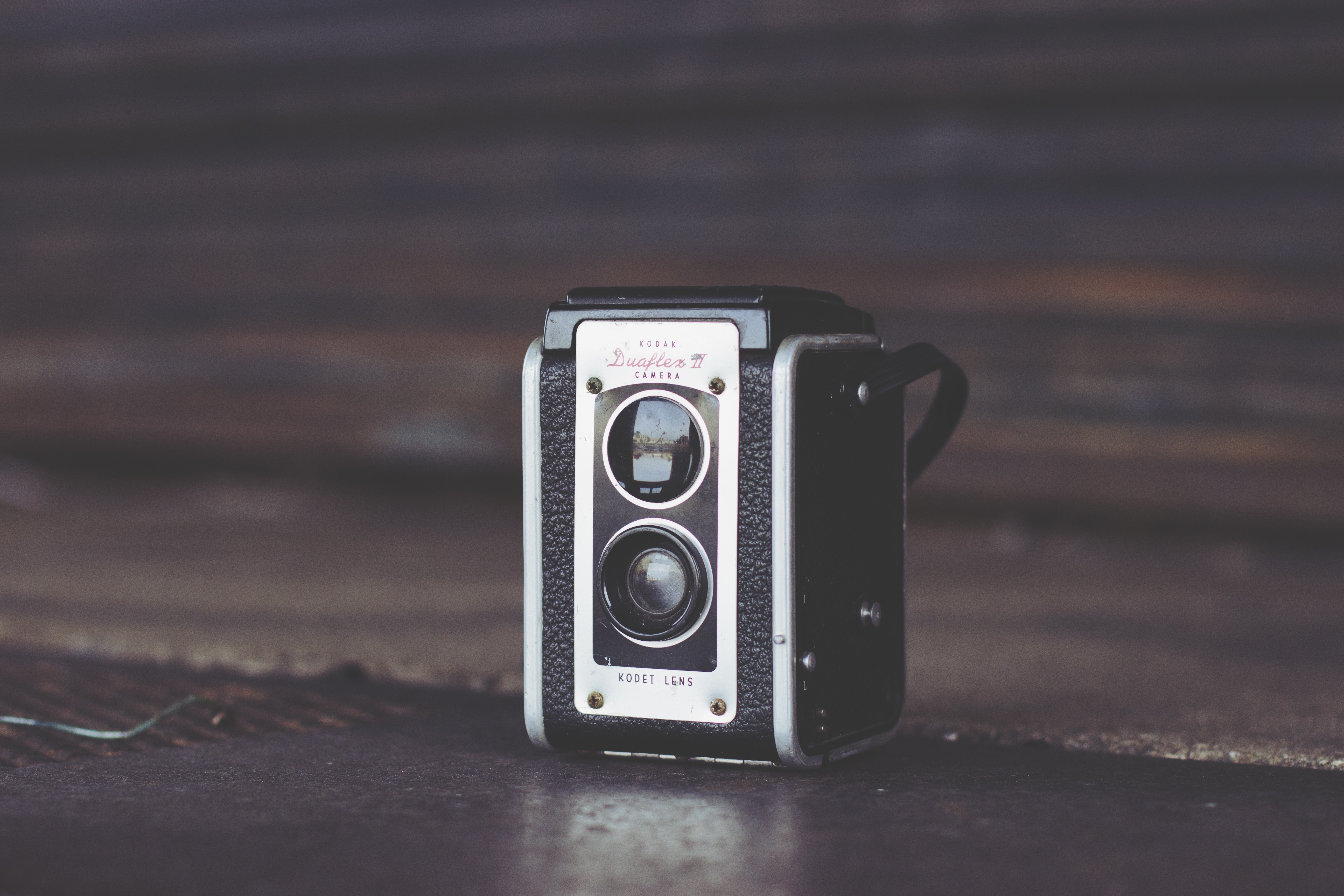 black and white camera on brown wooden top