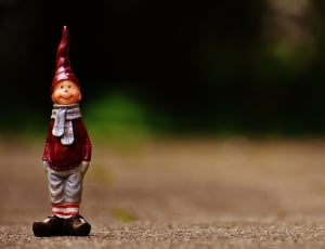 boy in red and grey dress figurine thumbnail