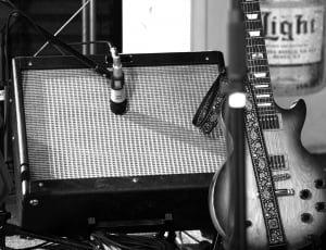 white and black les paul electric guitar and guitar amplifier thumbnail