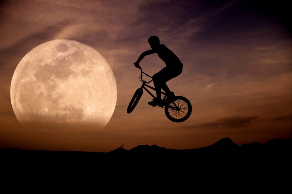 silhouette of man riding on bike preview