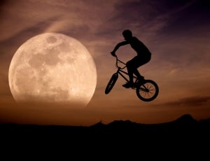silhouette of man riding on bike thumbnail