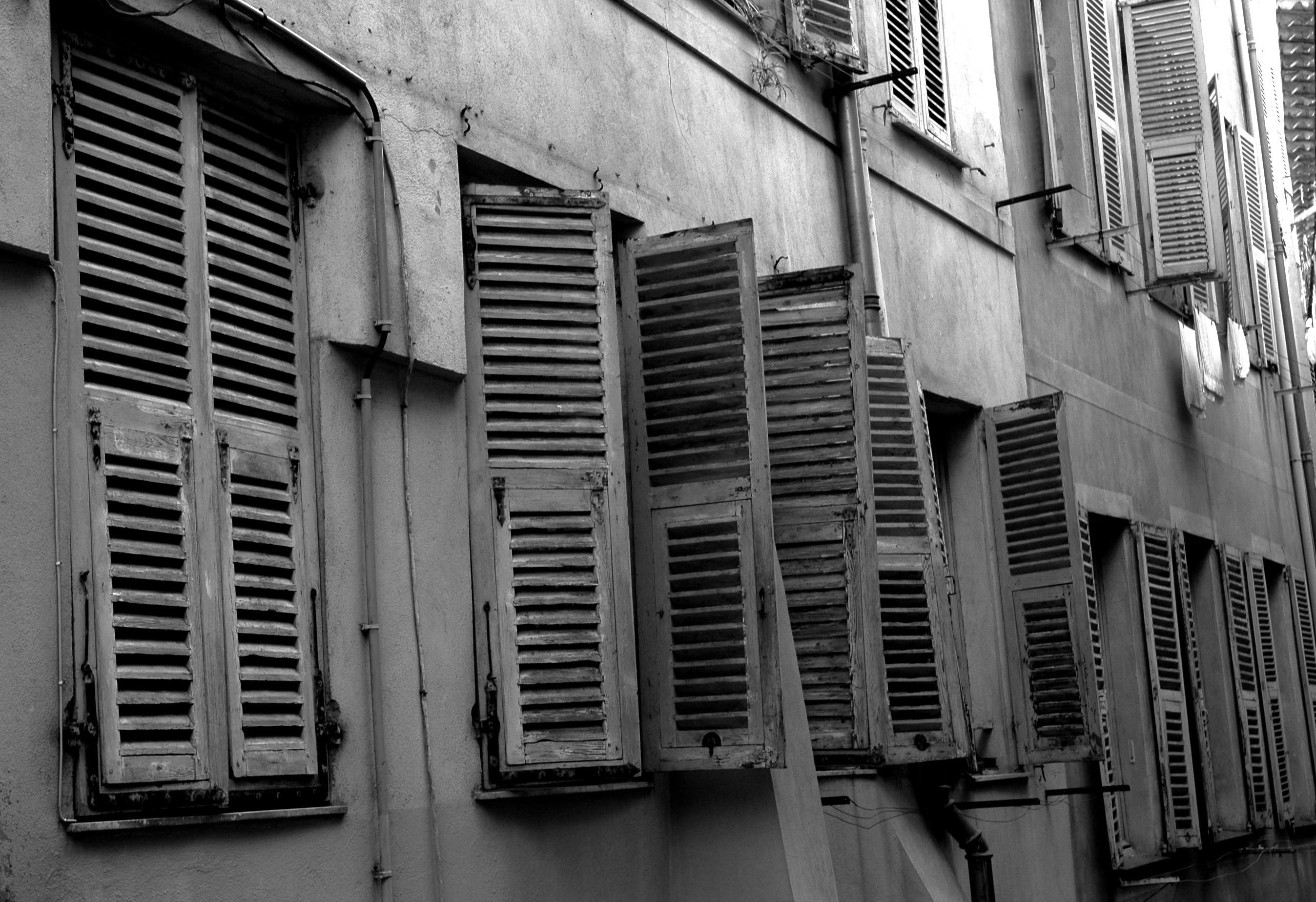 grayscale photo of wooden windows