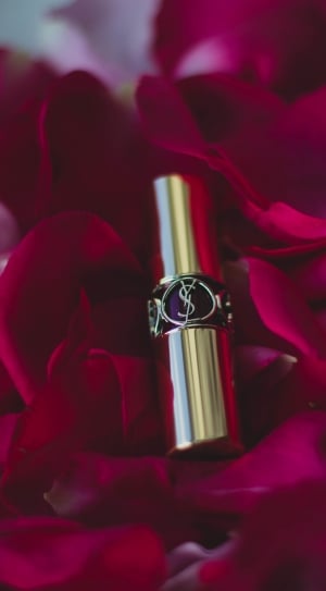yves saint laurent lipstick surrounded with red rose petals thumbnail