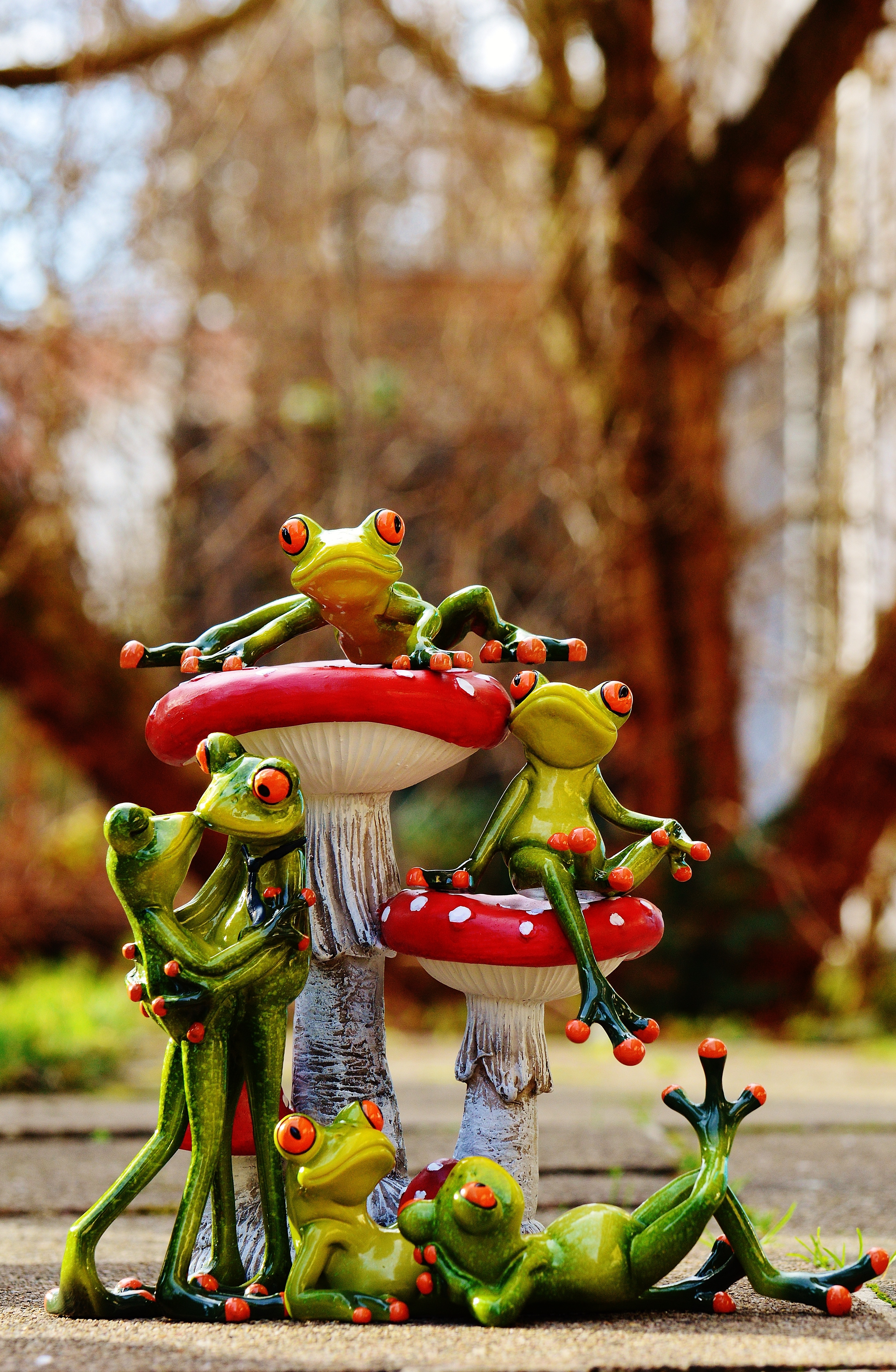 green frogs on red and white mushroom ceramic figurine