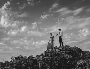 man and woman standing on rock thumbnail