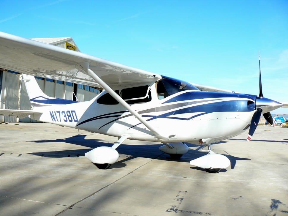 white and blue biplane preview