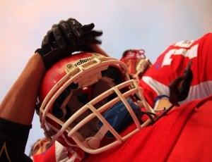 person in red football uniform and helmet thumbnail