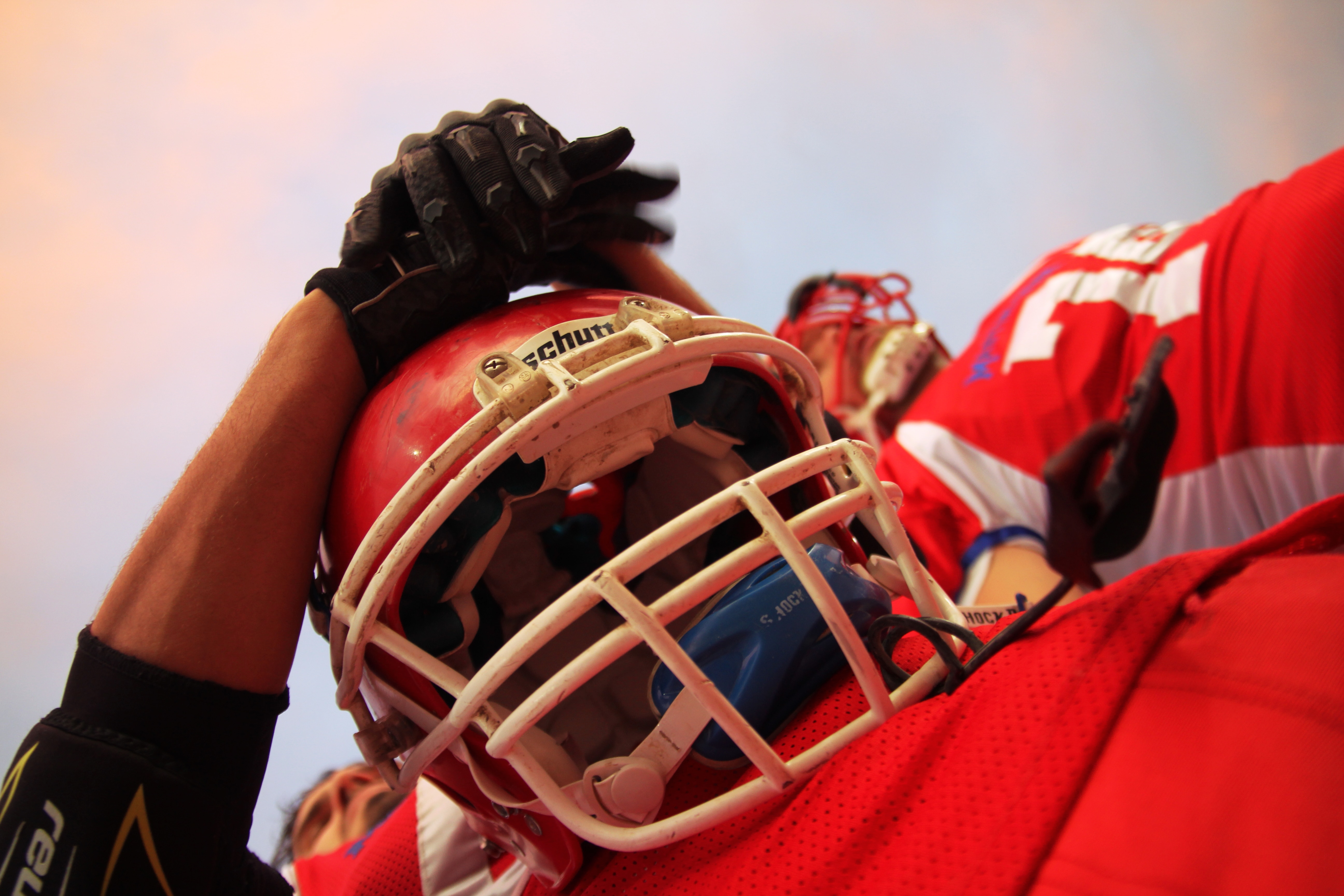 person in red football uniform and helmet