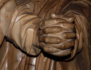 brown wooden person with claps hand sculpture thumbnail