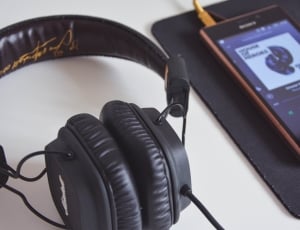 black corded headphones near black media player on thumbnail