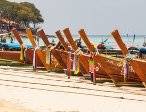 brown wooden boat lot ashore during daytime thumbnail