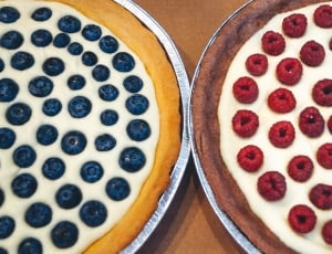 raspberry and blueberry pies in round trays thumbnail