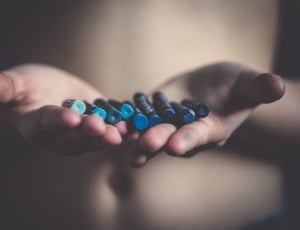 person holding blue crayons thumbnail