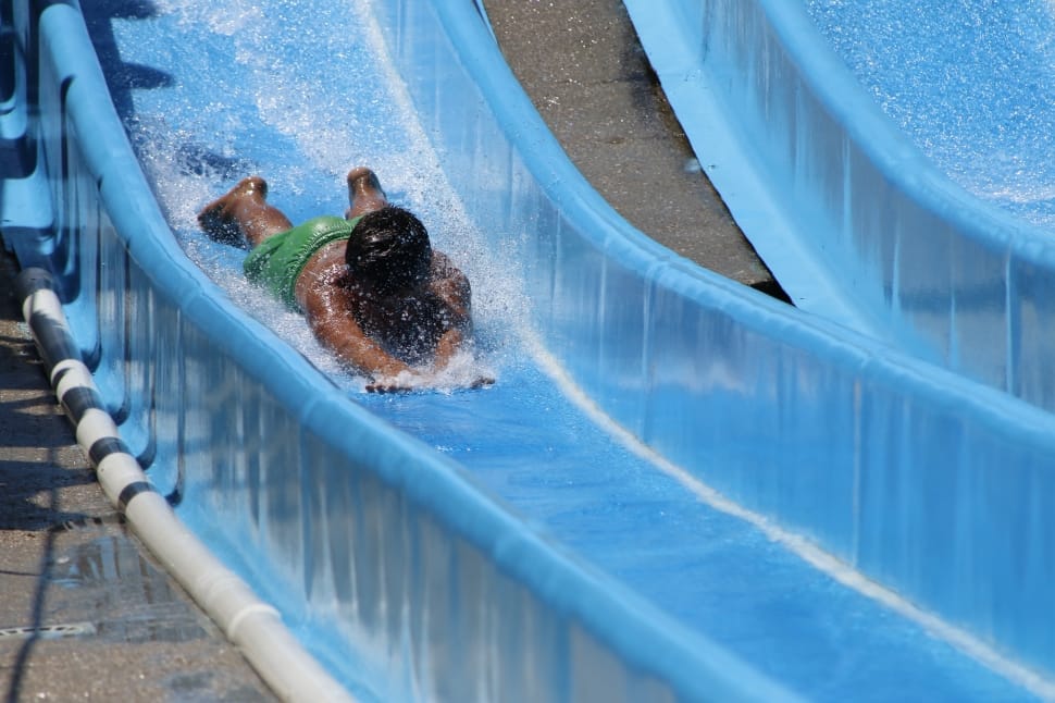 person at blue plastic slide during daytime preview