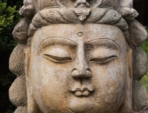 brown and grey ceramic buddha head sculpture thumbnail
