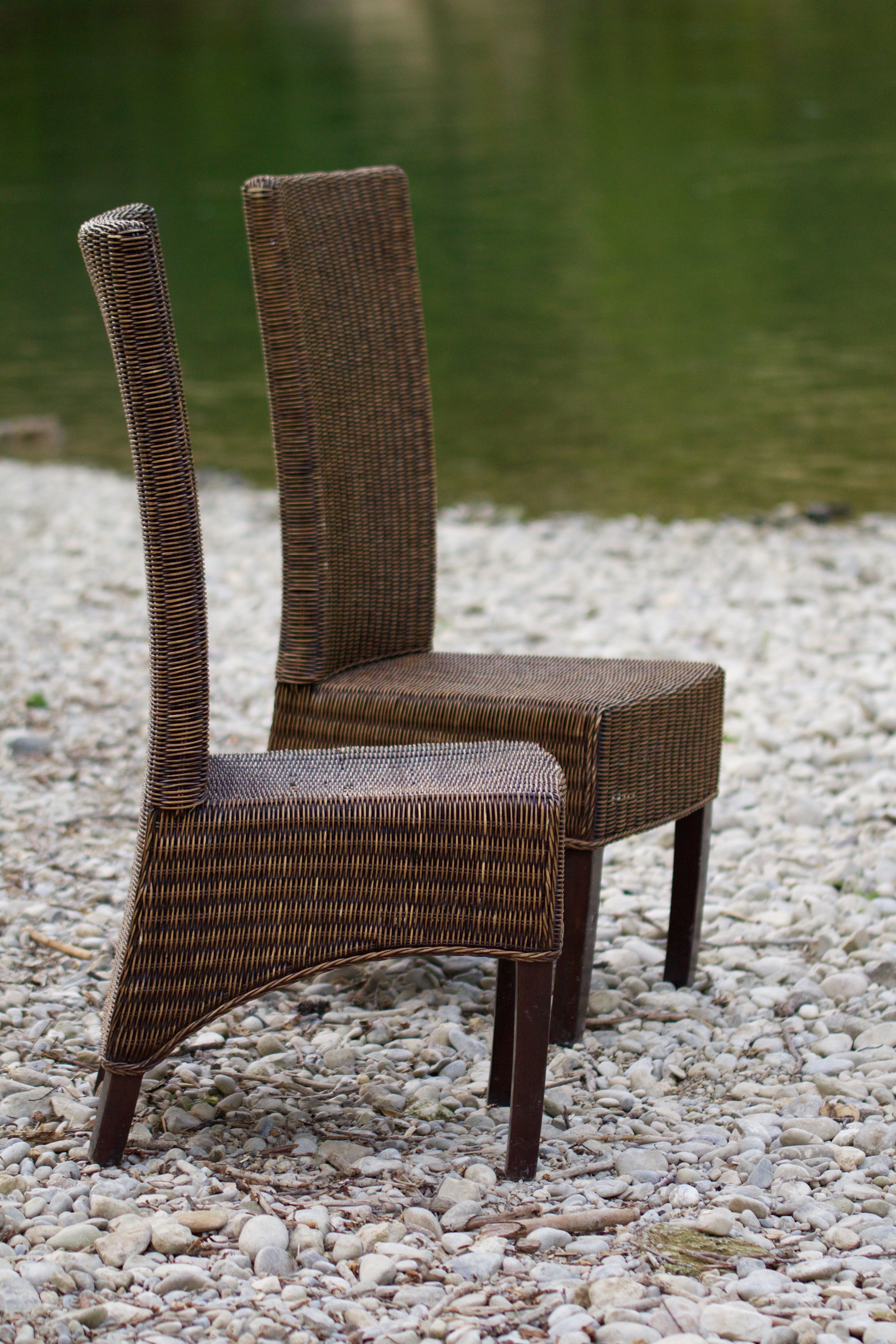 2 brown woven armless chairs