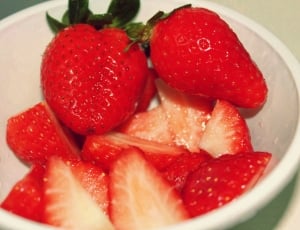 close up photo of strawberries in  white bowl thumbnail