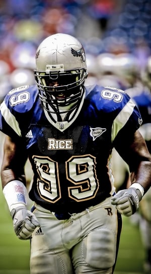 football player wearing black and blue Rice 99 football outfit photography thumbnail
