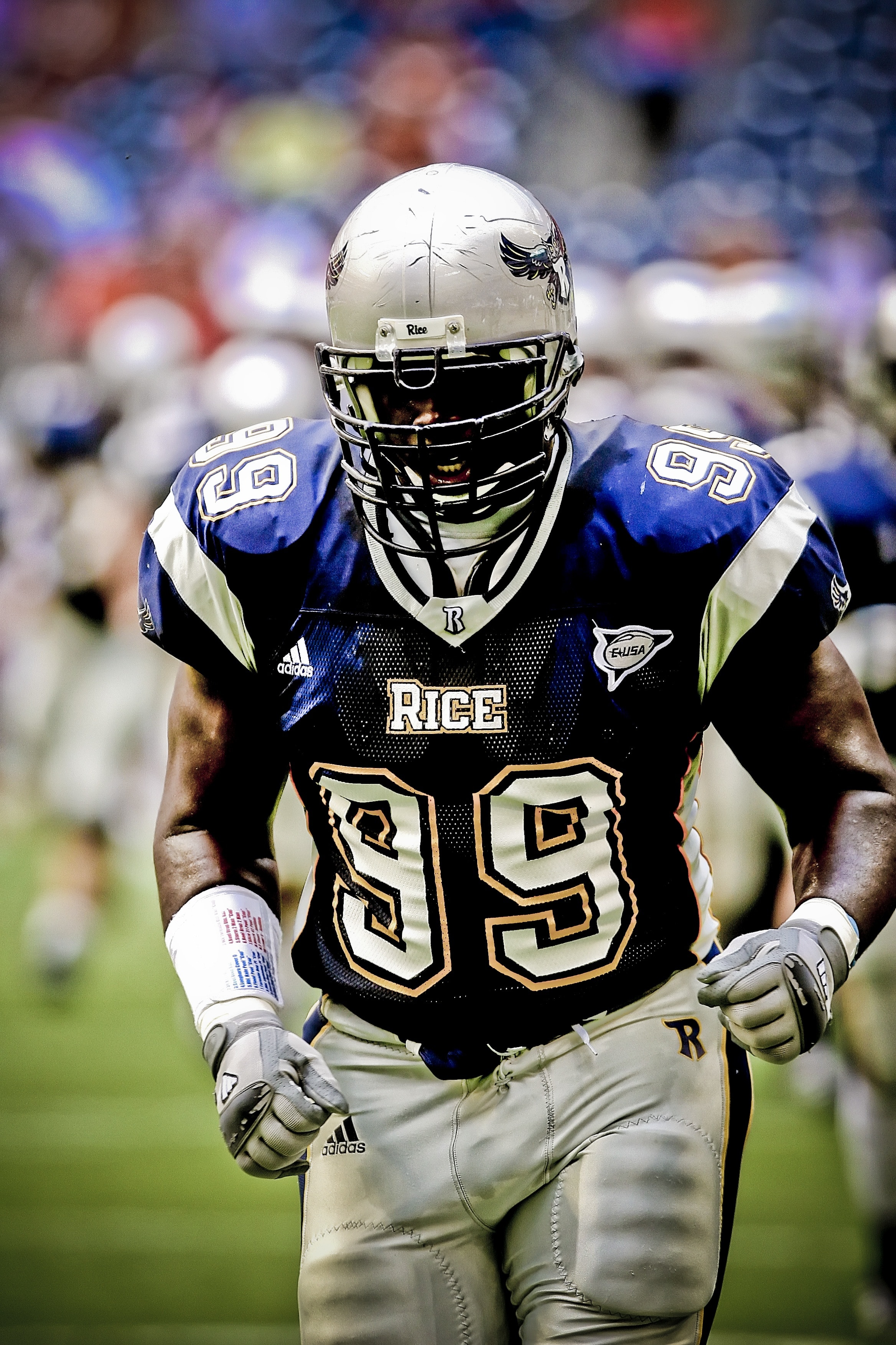 football player wearing black and blue Rice 99 football outfit photography