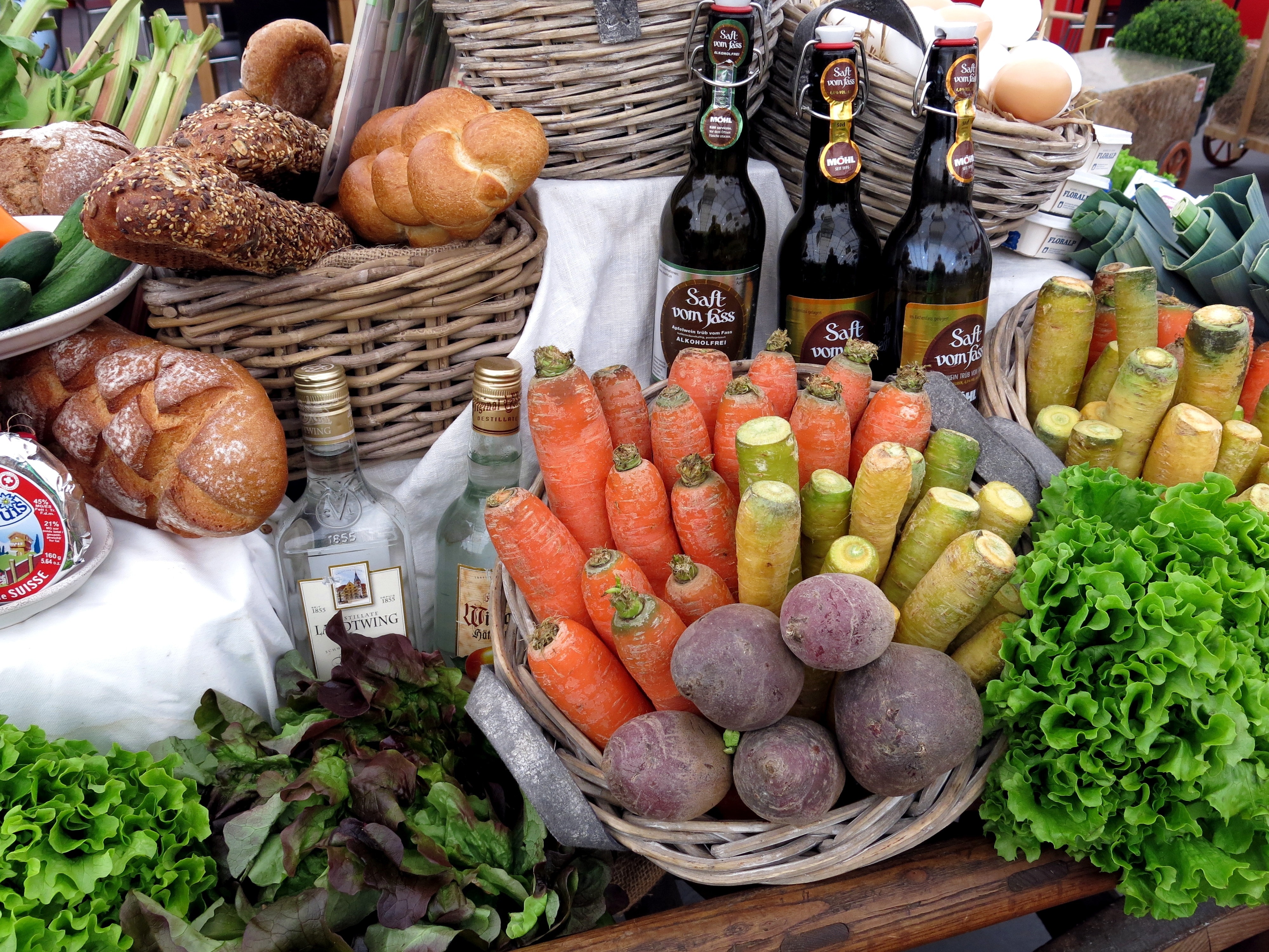 photo of variety of vegetable, wine, and bread on table