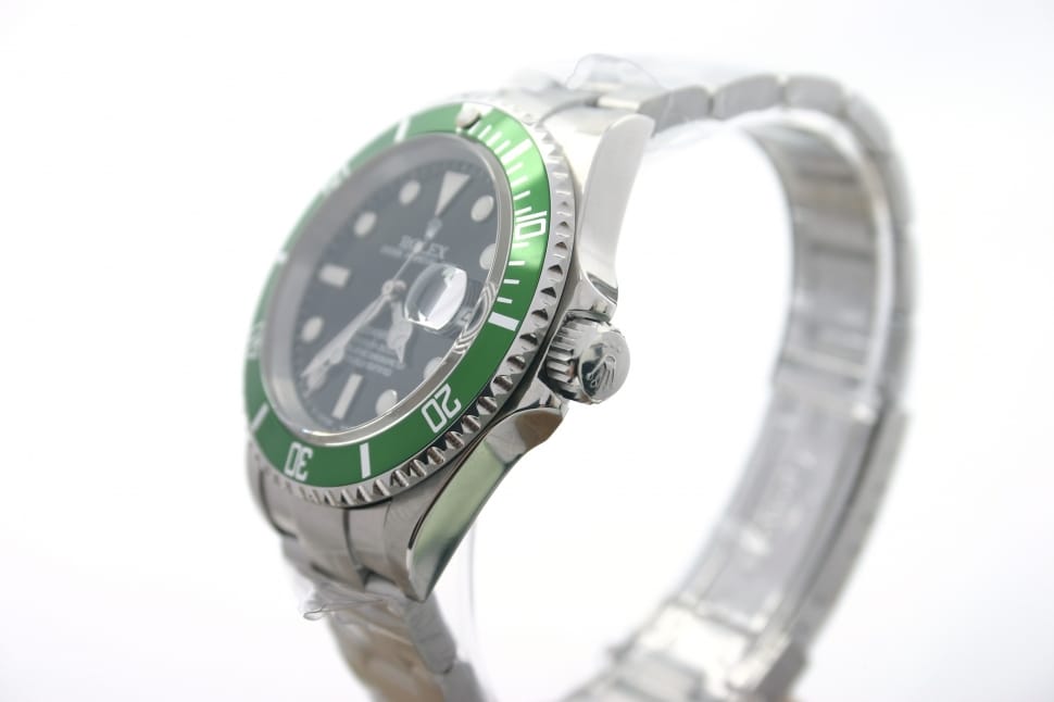 round green bezel Rolex analog watch with silver link strap preview