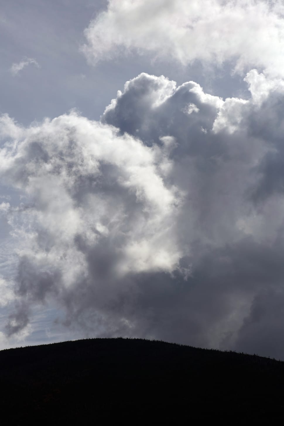 silhouette of mountain under white clouds at daytime preview