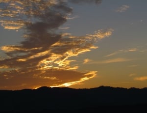 silhouette photo of mountain during dawn thumbnail