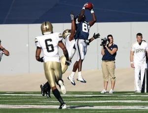american football player catching ball in middle of the air thumbnail