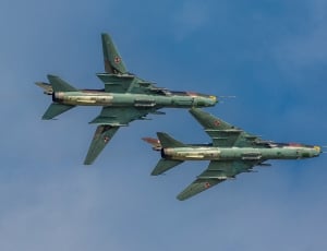 two blue-green fighter jets thumbnail