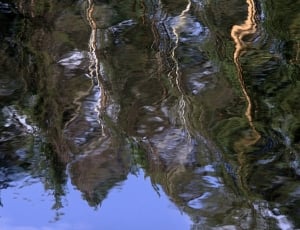 cliff reflecting on water with cripples closeup photo thumbnail