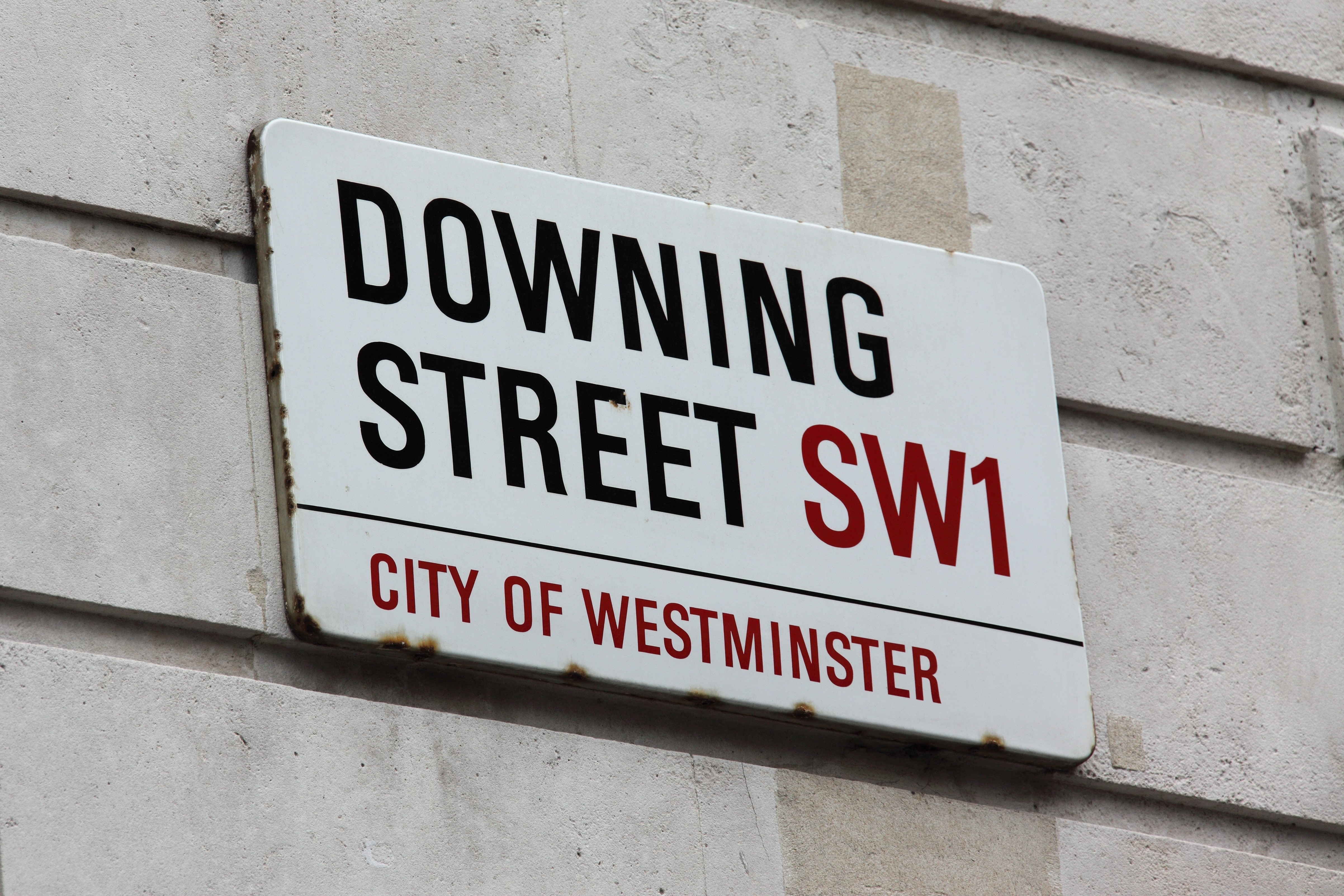 Downing Street SW1 signage on white concrete wall