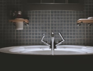 stainless steel faucet and white ceramic sink thumbnail