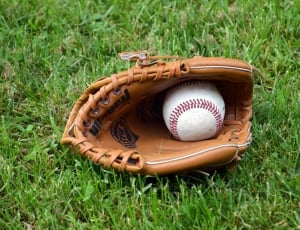 brown baseball mitt with baseball thumbnail