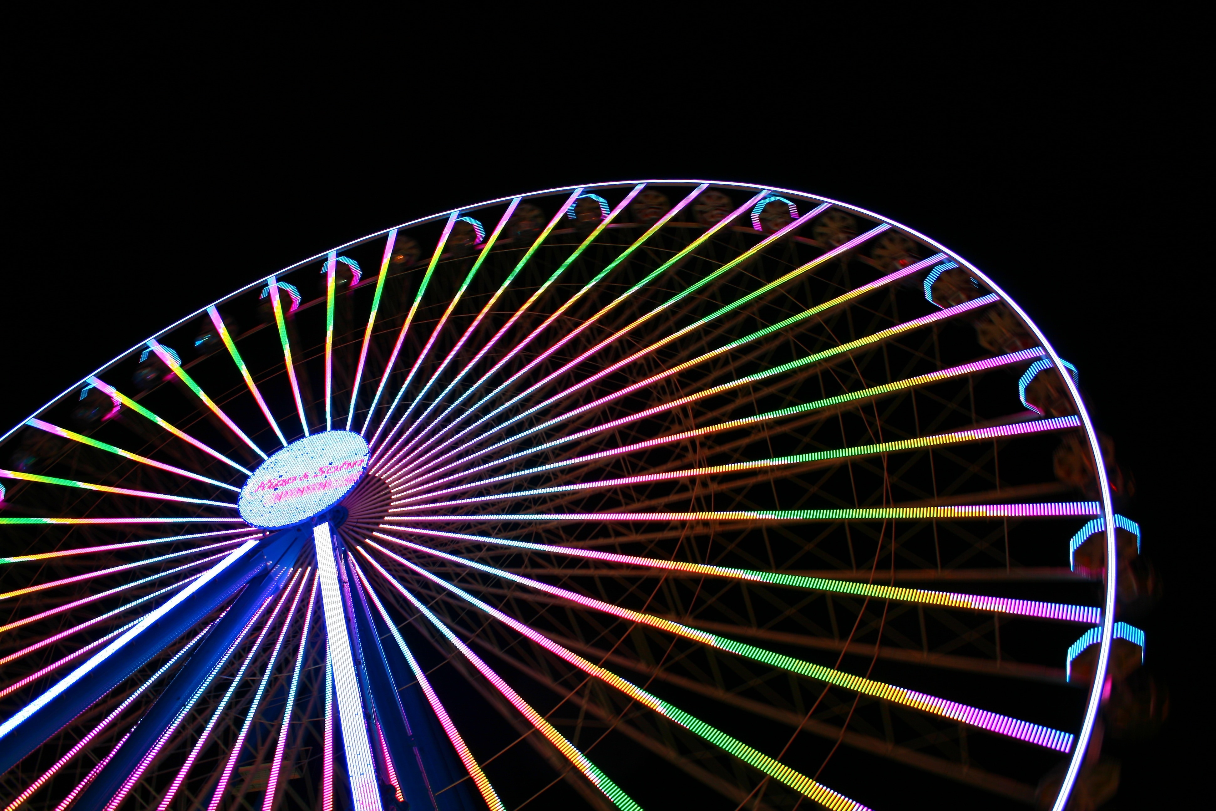 white pink and blue lighted suspension ferris wheel