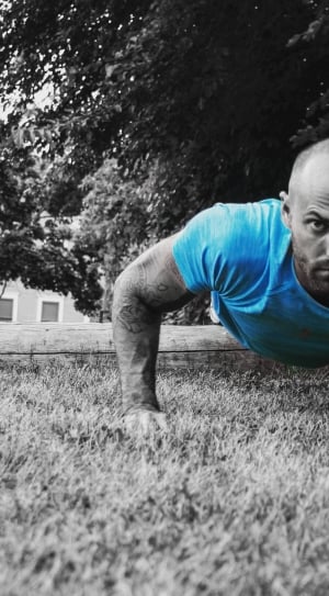 person wearing blue crew neck shirt while doing a push up thumbnail