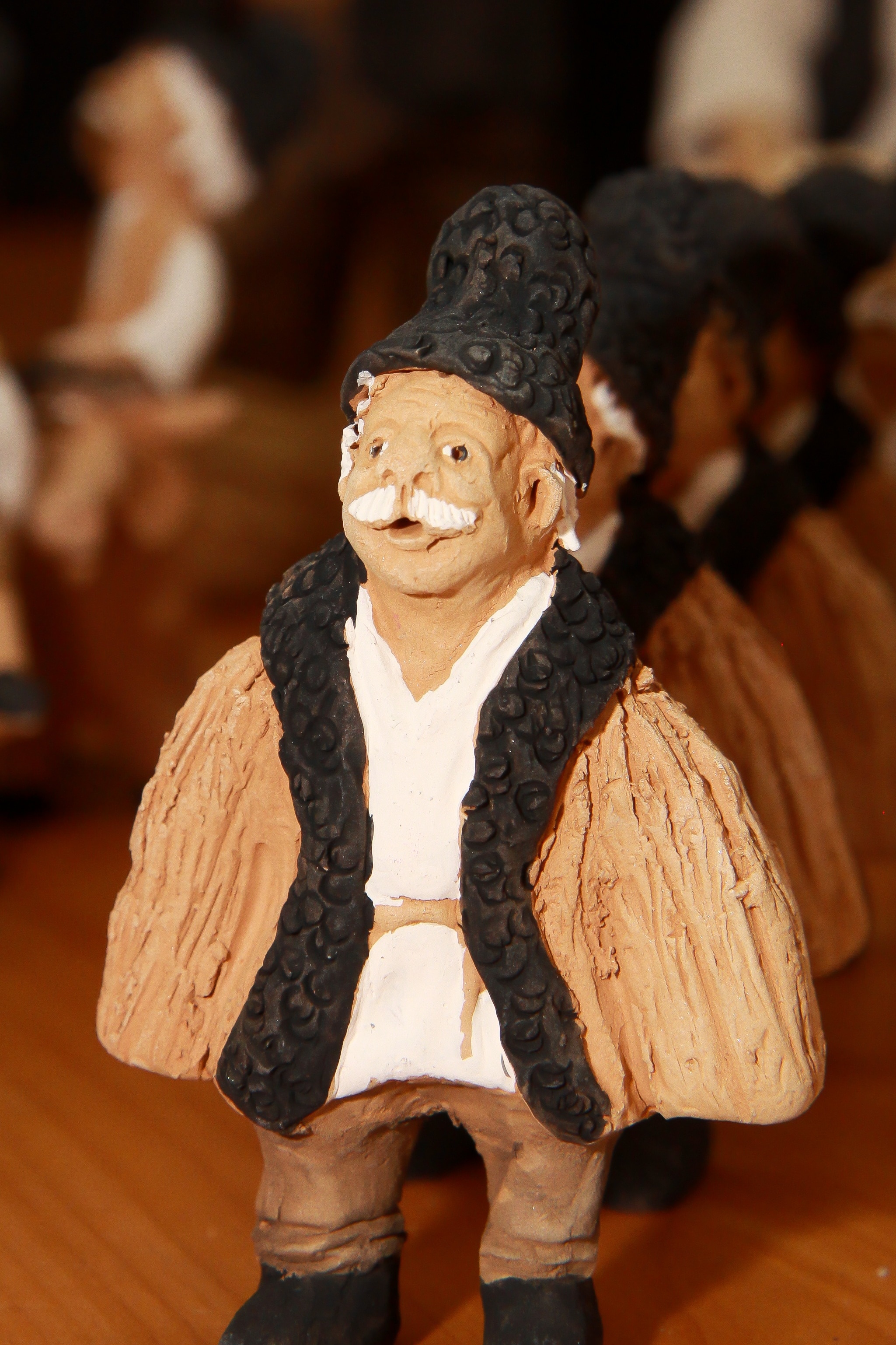 man in brown coat ceramic figurine