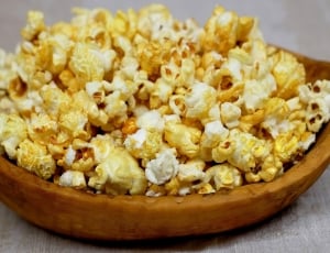 buttered popcorn with brown wooden bowl thumbnail