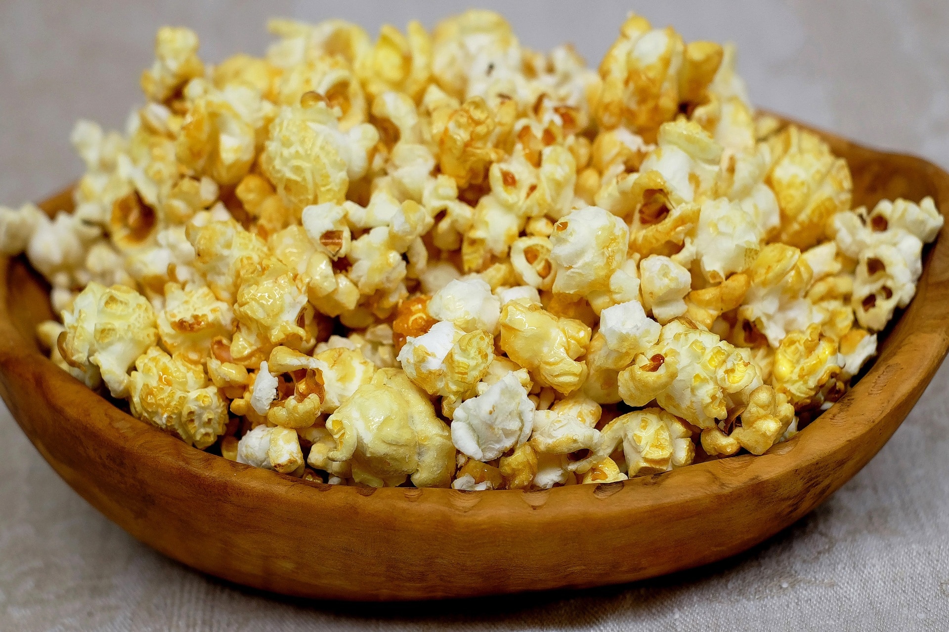 buttered popcorn with brown wooden bowl