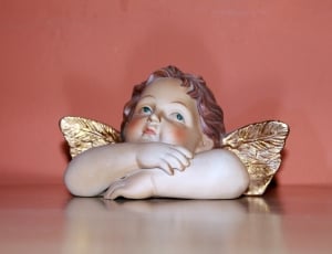 brown ceramic figurine of angel thumbnail