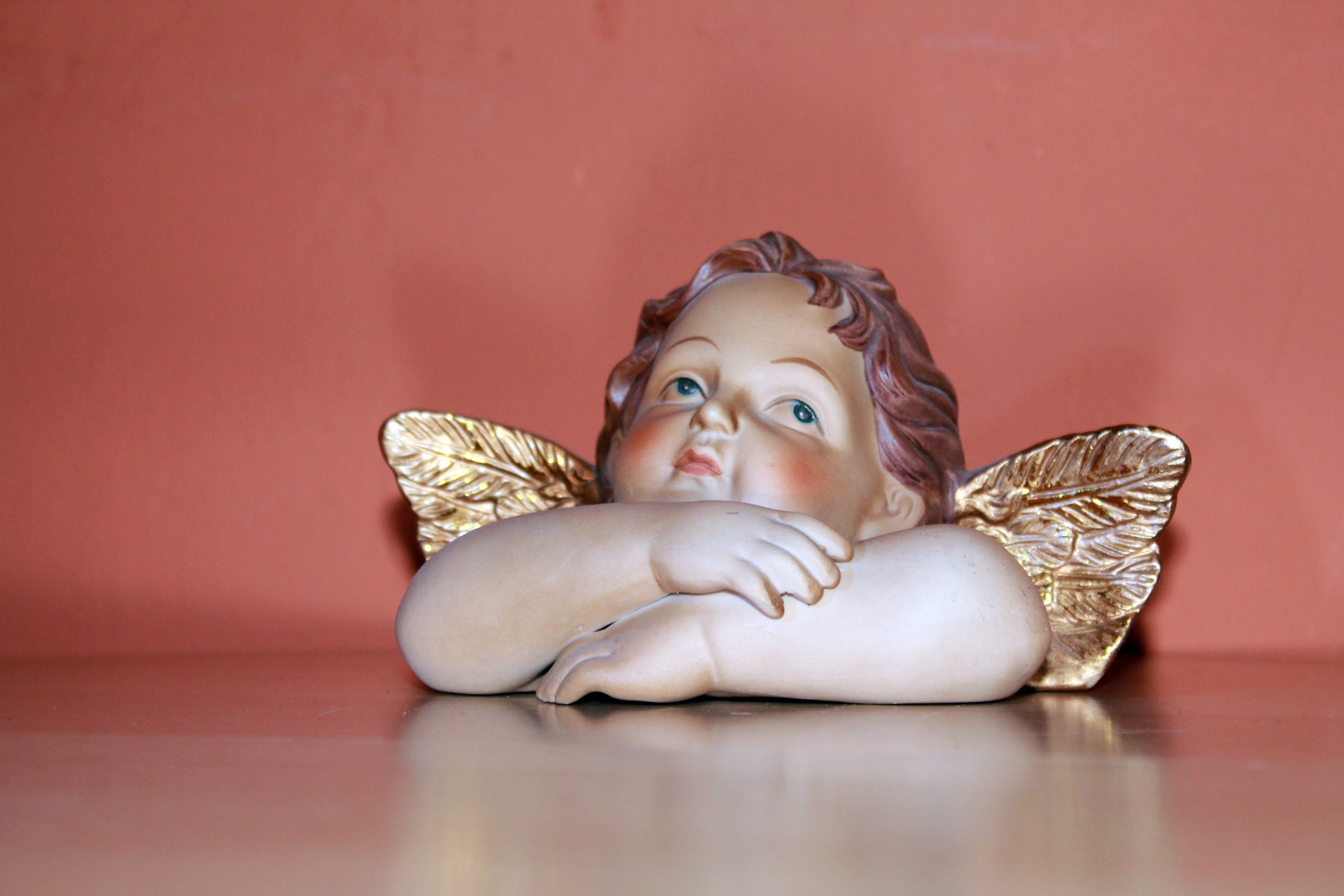brown ceramic figurine of angel