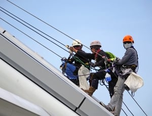 three men in roof climbing cables thumbnail