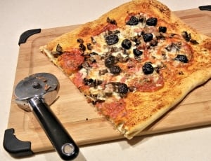 pizza, slicer and chopping board thumbnail