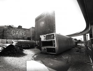 grayscale photography of train near buildings during daytime thumbnail