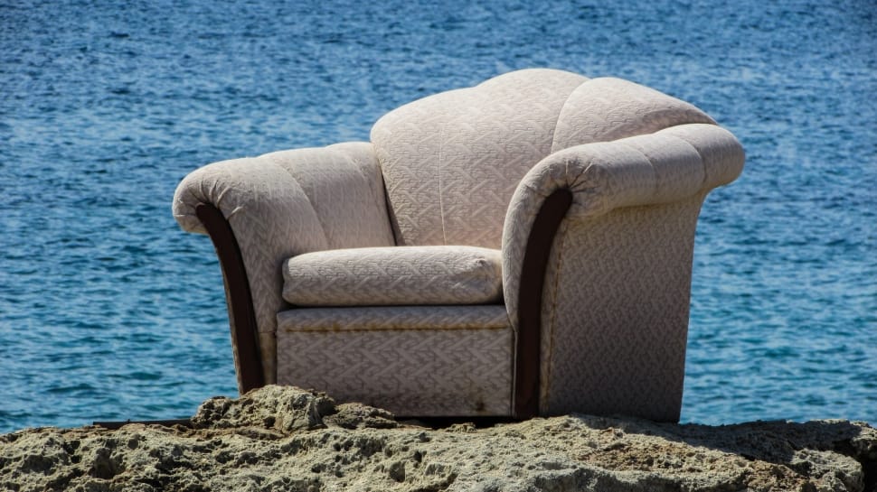 gray sofa chair at the sand dunes near body of water preview